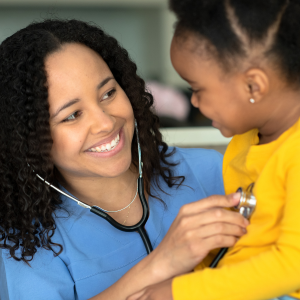 nurse listening to girls heart with stethescope 